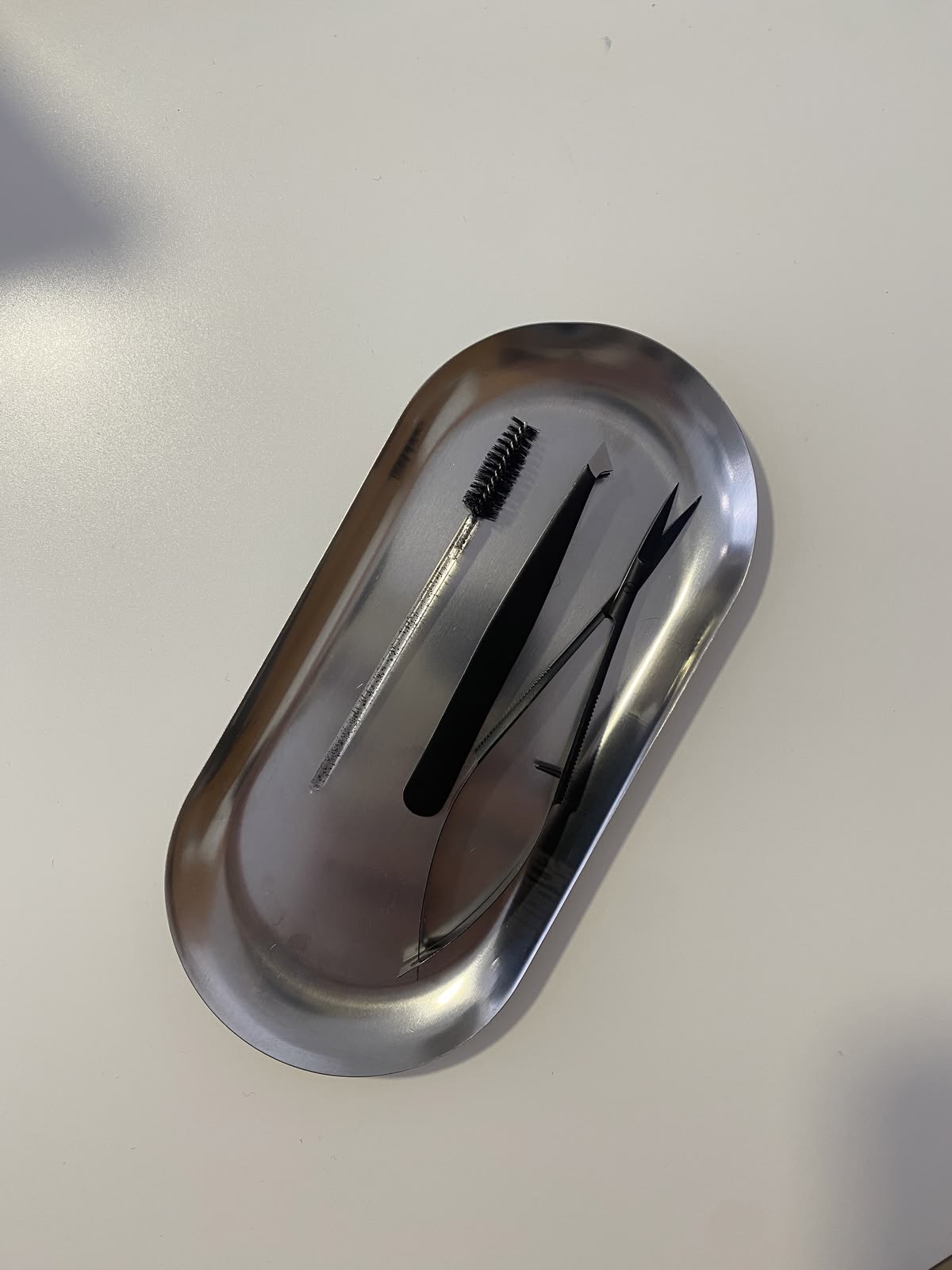 Professional brow tools prepared on a tray